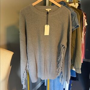 Fringed Gray Sweater on sleeve